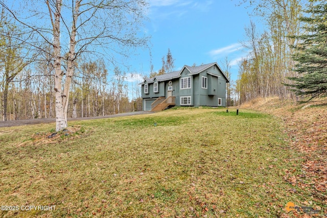 2751 N Barrys Resort Dr, Wasilla, AK 99654 - exterior space featuring a garage, aphalt driveway, a front yard, and a shingled roof