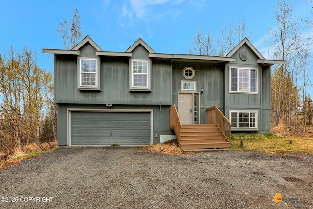 2751 N Barrys Resort Dr, Wasilla, AK 99654 - bi-level home featuring a garage and gravel driveway