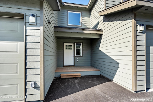 view of exterior entry featuring a garage