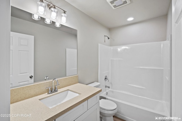 full bath with visible vents, vanity, toilet, and bathing tub / shower combination