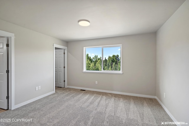 unfurnished bedroom featuring visible vents, baseboards, and carpet floors