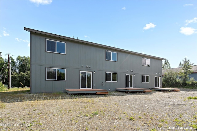 rear view of property featuring a wooden deck