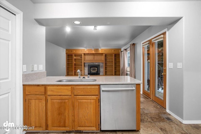 kitchen with visible vents, a peninsula, a sink, light countertops, and dishwasher