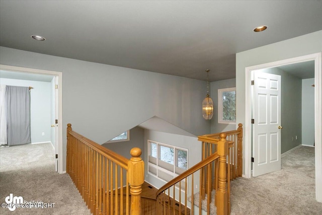 hall with recessed lighting, an upstairs landing, baseboards, and carpet floors