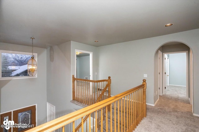 hallway featuring an upstairs landing, recessed lighting, arched walkways, carpet floors, and baseboards