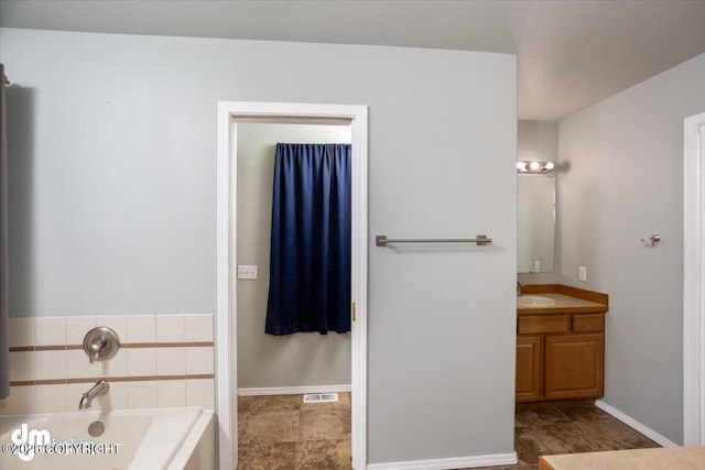 full bathroom with visible vents, baseboards, a bath, and vanity