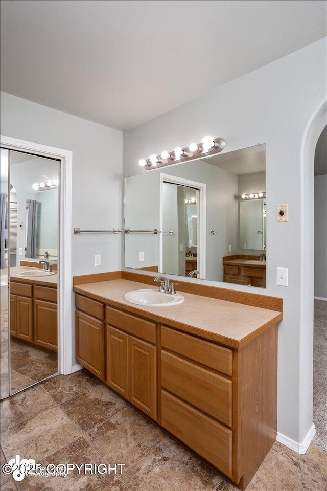 full bath featuring two vanities and a sink