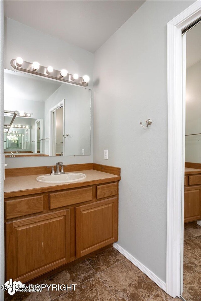 bathroom featuring baseboards and vanity