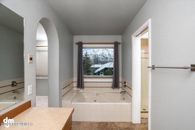 bathroom featuring vanity and a jetted tub