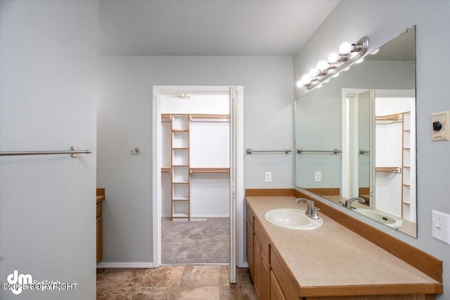 bathroom with vanity and baseboards