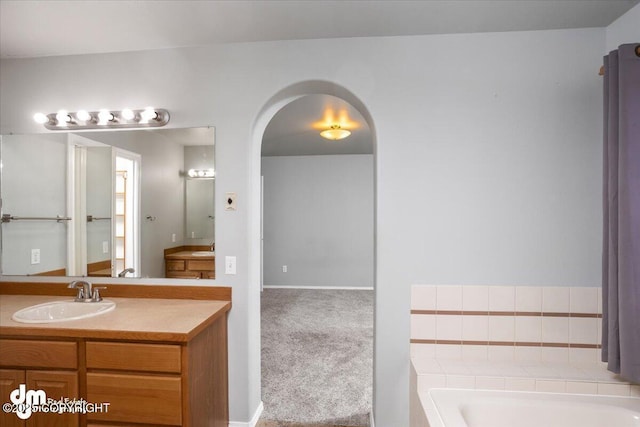 full bathroom featuring vanity and a bath