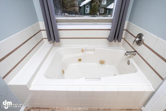 full bathroom with a whirlpool tub