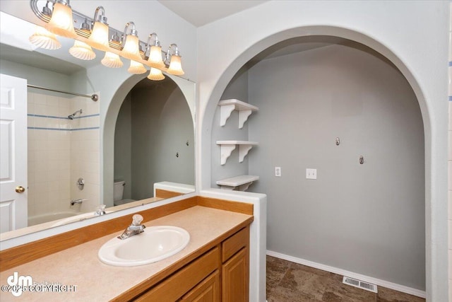 full bathroom with visible vents, toilet, shower / tub combination, baseboards, and vanity