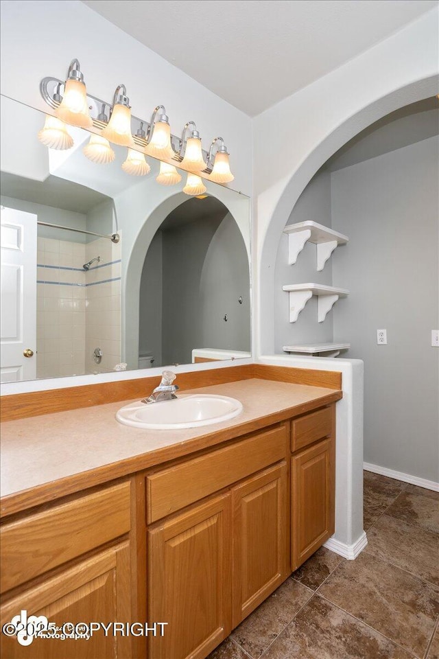 full bathroom featuring vanity, toilet, and a shower