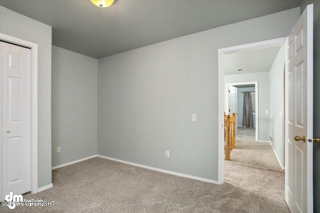 unfurnished bedroom with carpet flooring and baseboards