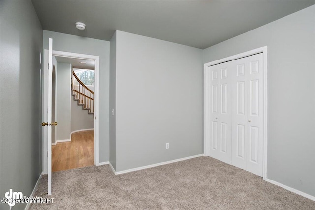 unfurnished bedroom with baseboards, a closet, and carpet floors