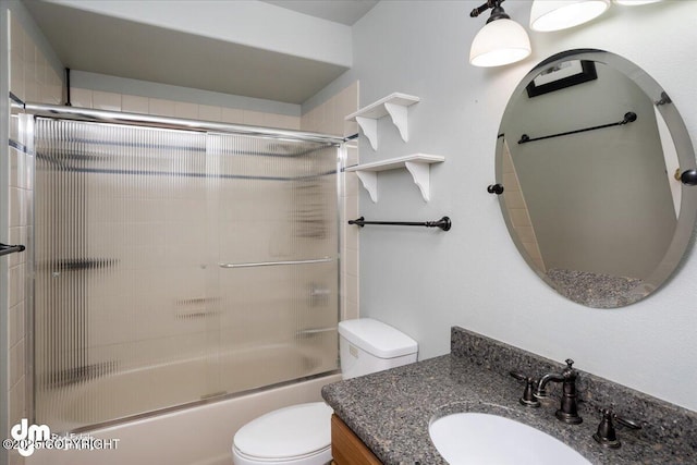 full bathroom featuring vanity, toilet, and enclosed tub / shower combo