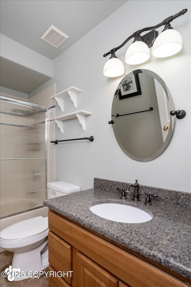 full bathroom with combined bath / shower with glass door, visible vents, toilet, and vanity