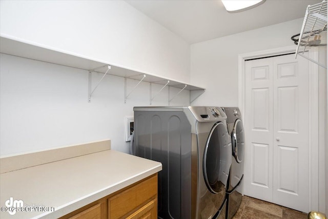 clothes washing area featuring independent washer and dryer and laundry area