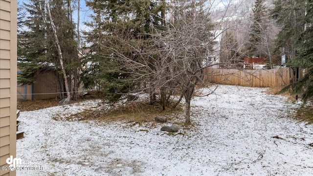 yard layered in snow with fence