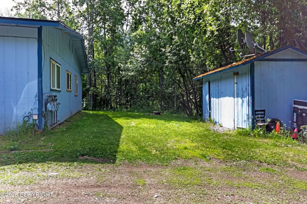 13968 W Holly Loop, Big Lake, AK 99623 - view of grassy yard featuring a storage shed