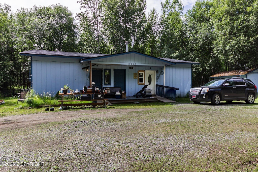 13968 W Holly Loop, Big Lake, AK 99623 - view of front of property with a porch, a front yard, and view of scattered trees