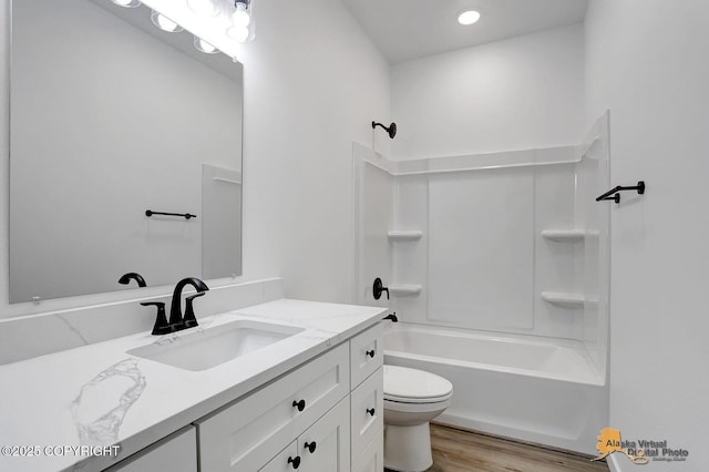 full bath with vanity, toilet, wood finished floors, and bathing tub / shower combination