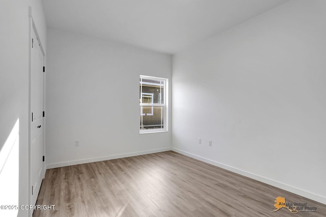 unfurnished bedroom with baseboards and wood finished floors