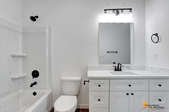 bathroom featuring tub / shower combination, toilet, vanity, and baseboards