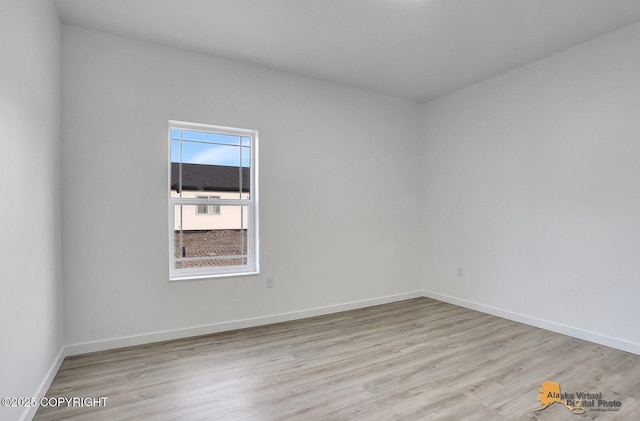 unfurnished room featuring light wood-style floors and baseboards