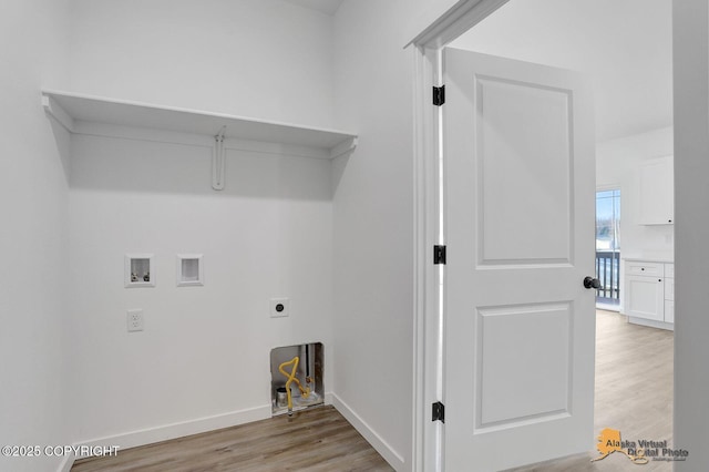 clothes washing area featuring baseboards, washer hookup, laundry area, light wood-style floors, and hookup for an electric dryer