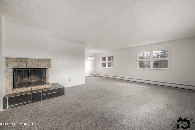 unfurnished living room featuring a chandelier, carpet floors, a stone fireplace, a textured ceiling, and a baseboard radiator