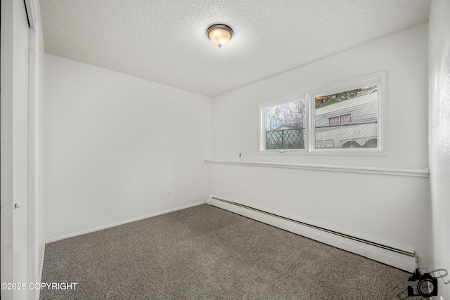 carpeted empty room with a textured ceiling, baseboards, and a baseboard radiator