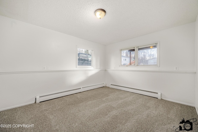 carpeted spare room featuring a textured ceiling and a baseboard radiator