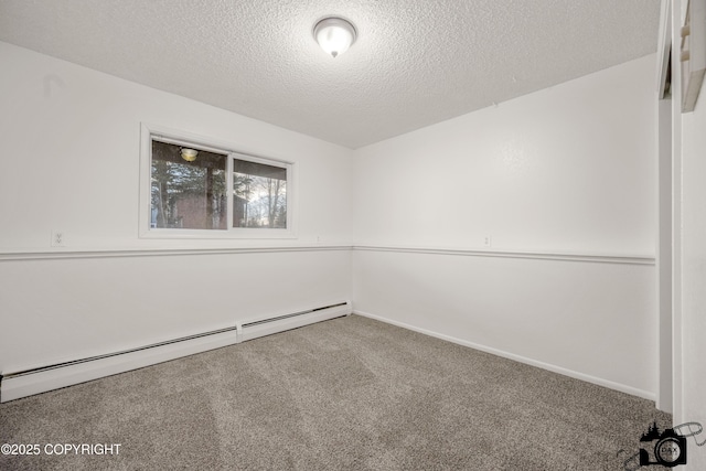 empty room featuring a baseboard heating unit, carpet, baseboards, and a textured ceiling