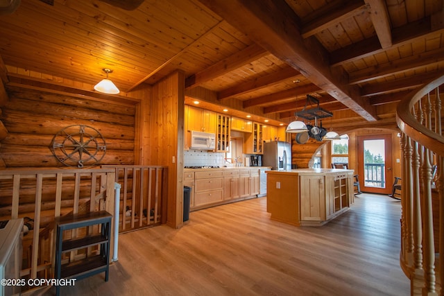 kitchen featuring white microwave, light wood-type flooring, light countertops, wooden ceiling, and stainless steel fridge