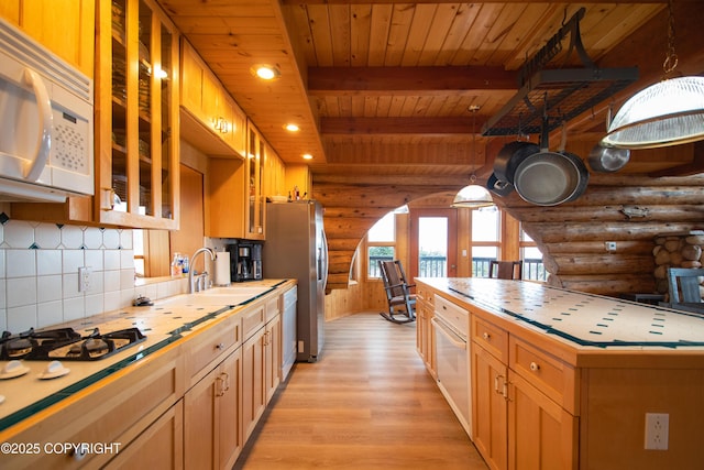 kitchen featuring backsplash, tile counters, light wood-style flooring, wooden ceiling, and white appliances