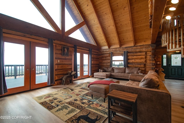 living room featuring french doors, beamed ceiling, wood finished floors, and wooden ceiling