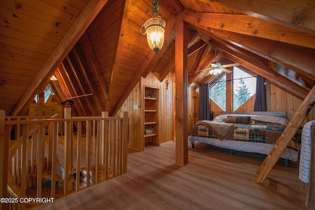 bedroom featuring lofted ceiling with beams, wooden walls, wood finished floors, and wooden ceiling