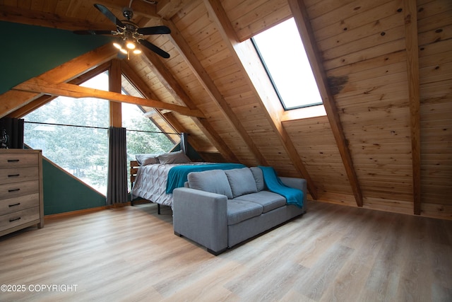 unfurnished bedroom with vaulted ceiling with skylight, wood ceiling, and light wood finished floors