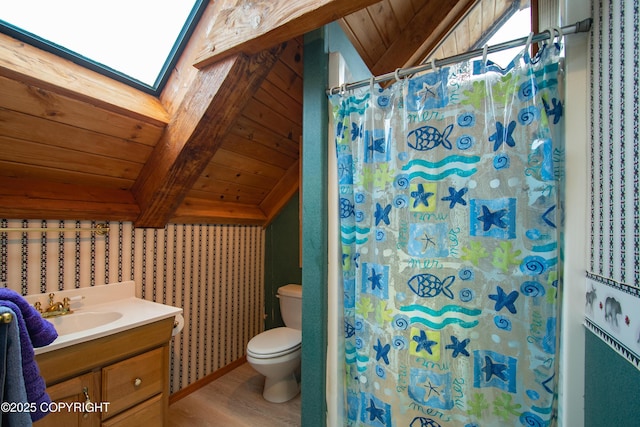 bathroom featuring lofted ceiling with skylight, toilet, wood ceiling, a shower with curtain, and vanity