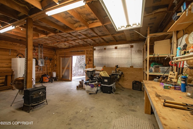 garage featuring electric panel and freestanding refrigerator