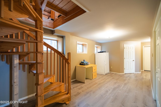 interior space featuring wood finished floors and baseboards