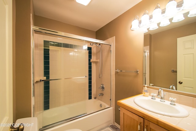 bathroom with combined bath / shower with glass door and vanity