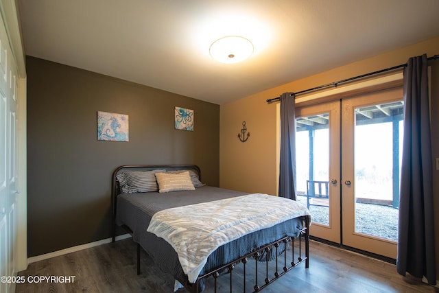 bedroom featuring french doors, baseboards, wood finished floors, and access to outside