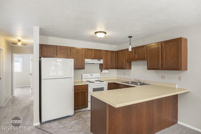 kitchen featuring under cabinet range hood, a sink, white appliances, a peninsula, and light countertops