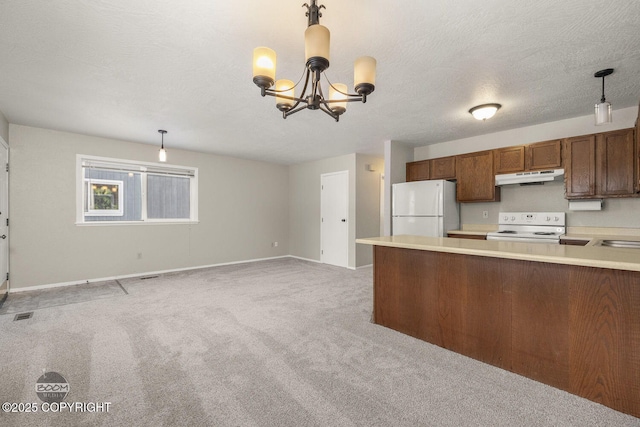 kitchen with white appliances, light countertops, under cabinet range hood, light carpet, and a chandelier