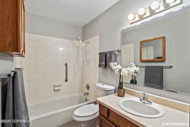 full bath with a textured wall, vanity, shower / bathtub combination, toilet, and a textured ceiling