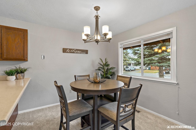 dining area featuring baseboards, visible vents, light carpet, and a notable chandelier