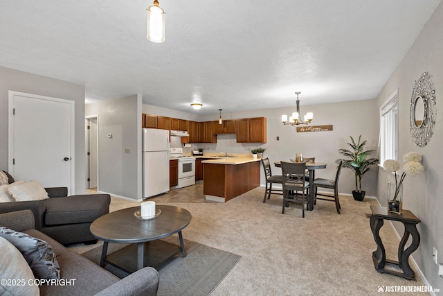 living room featuring an inviting chandelier, baseboards, and light colored carpet